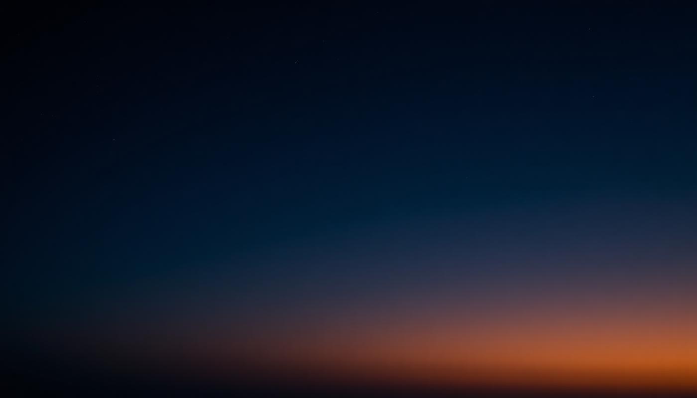 Night sky fading into a warm dawn horizon